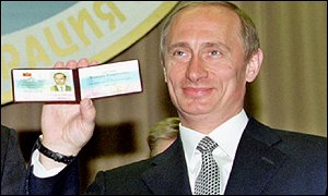 Vladimir Putin displays his election identity card