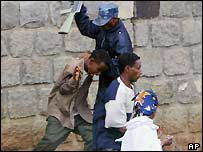 Ethiopian policeman beating students