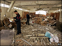 YMCA staff inspect the damage done to their library (15 February 2008)
