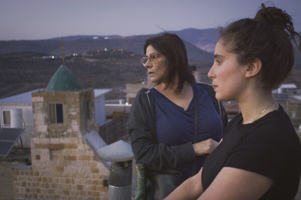 This image released by Beall Productions shows Palestinian actress Hiam Abbass, left, and Lina Soualem in a scene from the documentary "Bye Bye Tiberias." (Frida Marzouk/Beall Productions via AP)