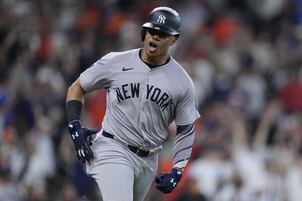 New York Yankees' Juan Soto celebrates after hitting an RBI single during the ninth inning of the team's baseball game against the Houston Astros, Sunday, March 31, 2024, in Houston. (AP Photo/Kevin M. Cox)