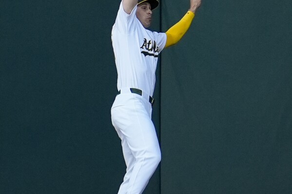 Oakland Athletics center fielder JJ Bleday is unable to catch a fly ball hit by Boston Red Sox's Enmanuel Valdez during the second inning of a baseball game Monday, April 1, 2024, in Oakland, Calif. Valdez reached second on the fielding error. (AP Photo/Godofredo A. Vásquez)