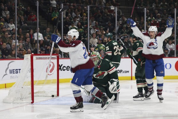 Colorado Avalanche left wing Jonathan Drouin (27) celebrates a goal against Minnesota Wild goaltender Filip Gustavsson (32) during the second period of an NHL hockey game Thursday, April 4, 2024, in St. Paul, Minn. (AP Photo/Stacy Bengs)