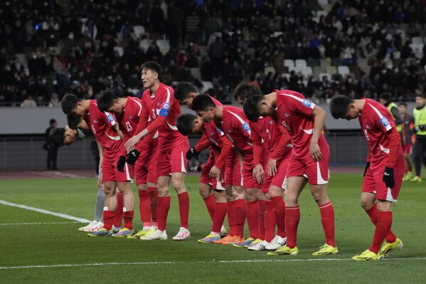 North Korea's players greet their supporters at the end of the FIFA World Cup 2026 and AFC Asian Cup 2027 preliminary joint qualification round 2 match between Japan and North Korea at the National Stadium Thursday, March 21, 2024, in Tokyo. (AP Photo/Eugene Hoshiko)