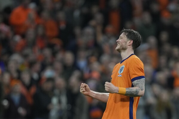 Netherlands' Wout Weghorst celebrates after scoring his side's third goal during an international friendly soccer match between Netherlands and Scotland at the Johan Cruyff ArenA, in Amsterdam, Netherlands, Friday, March 22, 2024. (AP Photo/Peter Dejong)