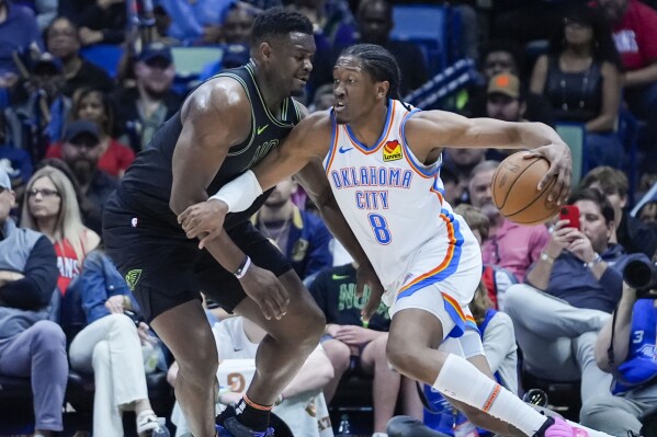 Oklahoma City Thunder forward Jalen Williams (8) drives to the basket against New Orleans Pelicans forward Zion Williamson in the first half of an NBA basketball game in New Orleans, Tuesday, March 26, 2024. (AP Photo/Gerald Herbert)