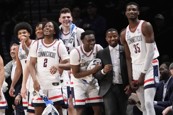 UConn guard Tristen Newton (2) and his teammates react in the final seconds of the second half of a second-round college basketball game against Northwestern in the NCAA Tournament, Sunday, March 24, 2024, in New York. UConn won 75-58. (AP Photo/Mary Altaffer)