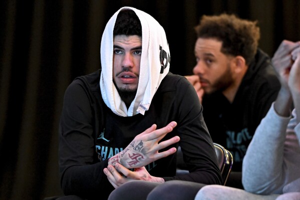 Charlotte Hornets guard LaMelo Ball looks on during an NBA basketball press conference to introduce new executive vice president of basketball operations, Jeff Peterson, Wednesday, March 6, 2024, in Charlotte, N.C. (AP Photo/Matt Kelley)
