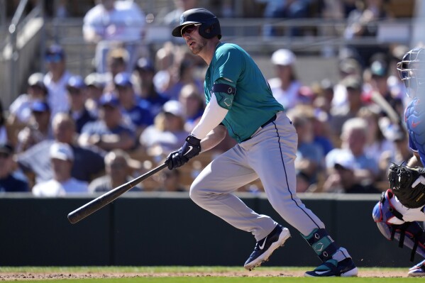 Seattle Mariners' Mitch Garver watches his two-run double against the Los Angeles Dodgers during the fifth inning of a spring training baseball game Wednesday, March 13, 2024, in Phoenix. (AP Photo/Ross D. Franklin)