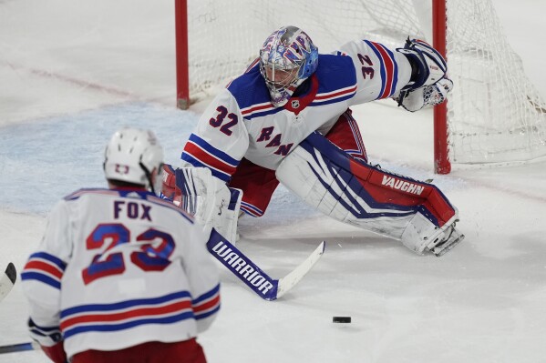 New York Rangers goaltender Jonathan Quick (32) strops a shot on goal against the Arizona Coyotes during the third period of an NHL hockey game, Saturday, March 30, 2024, in Tempe, Ariz. (AP Photo/Matt York)