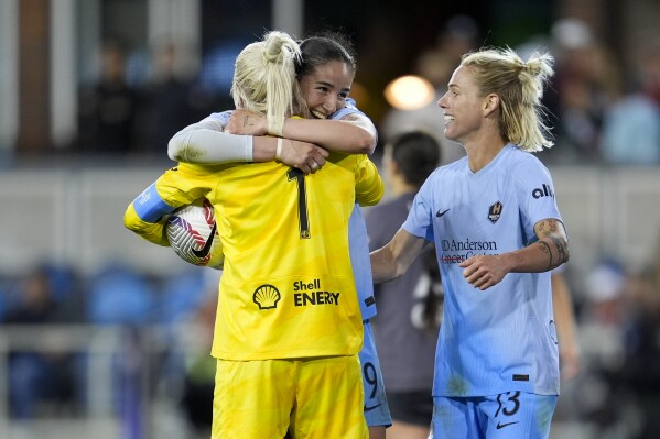 Houston Dash forward Diana Ordóñez, center, hugs goalkeeper Jane Campbell after the team's victory over Bay FC in an NWSL soccer match Saturday, March 30, 2024, in San Jose, Calif. (AP Photo/Godofredo A. Vásquez)