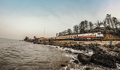 Kereta api sedang melintas di tepi pantai di dekat Plabuan, Gringsing, Batang
