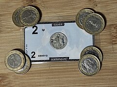 Pièces de monnaie contremarquées de 1 euros au 4 coins d'un silver certificate.jpg