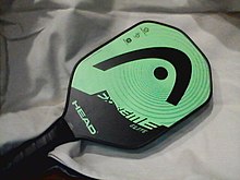 Raqueta o pala para jugar al deporte del pickleball, de la marca Head y color verde y negro.
