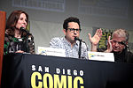 (Từ trái sang phải) Nhà sản xuất Kathleen Kennedy, đạo diễn kiêm nhà biên kịch J. J. Abrams và nhà biên kịch Lawrence Kasdan phát biểu tại sự kiện San Diego Comic-Con International 2015.
