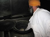Making tandoor bread in India