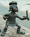 Image 73Statue of Minnie the Minx, a character from The Beano. Launched in 1938, the comic is known for its anarchic humour, with Dennis the Menace appearing on the cover. (from Children's literature)