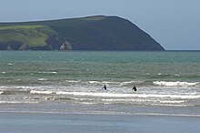 People surfing at a beach in Pembrokeshire