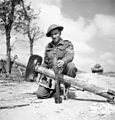 1944 - Sergeant V.R. Francis, 19th Field Regiment, Royal Canadian Artillery (R.C.A.), displaying a German 88mm anti-tank rocket launcher (Panzerschreck) discovered at a captured German radar station, France.