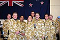 New Zealanders soldiers in front of flag