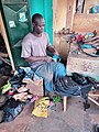 A Cobbler mending a boot in Northern Ghana 01