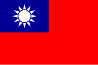 A red flag, with a small blue rectangle in the top left hand corner on which sits a white sun composed of a circle surrounded by 12 rays.