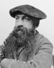 Photo of Rodin wearing a beret, looking into the distance.