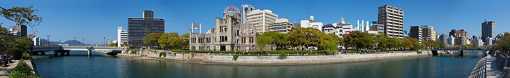 180° view of Hiroshima Peace Memorial Park. The Genbaku Dome can be seen in the center left of the image. The original target for the bomb was the "T"-shaped Aioi Bridge seen in the left of the image.