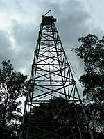 A bottom-up view of an old iron oil derrick