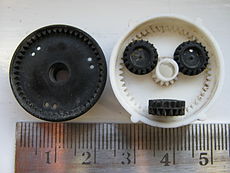 Split ring, compound planet, epicyclic gears of a car rear-view mirror positioner. This has a ratio from input sun gear to output black ring gear of −5/352.