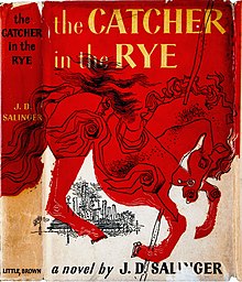 Cover features a drawing of a carousel horse (pole visible entering the neck and exiting below on the chest) with a city skyline visible in the distance under the hindquarters. The cover is two-toned: everything below the horse is whitish while the horse and everything above it is a reddish orange. The title appears at the top in yellow letters against the reddish orange background. It is split into two lines after "Catcher". At the bottom in the whitish background are the words "a novel by J. D. Salinger".