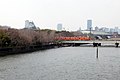 平野川橋梁を渡る大阪環状線の列車と大坂城天守および大阪城ホール。
