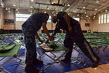Morale, Welfare and Recreation employees assembling and checking emergency preparation kits in Joint Base Pearl Harbor–Hickam in advance of Hurricane Lane