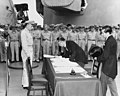 Foreign Minister Mamoru Shigemitsu signs the Instrument of Surrender on behalf of the Japanese Government during formal surrender ceremonies on the USS MISSOURI in Tokyo Bay, September 2, 1945.