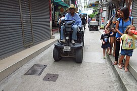 A man driving a village vehicle on Lamma Island in Hong Kong