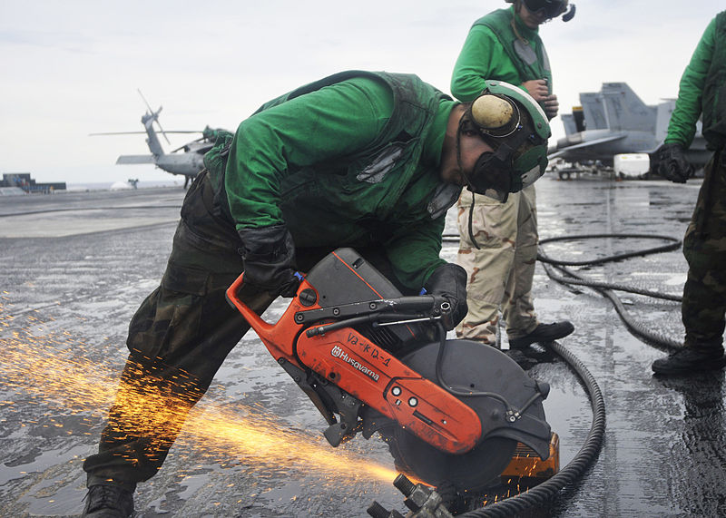 File:US Navy 100922-N-7103C-091 Aviation Boatswain's Mate 3rd Class Max Torres, from Houston, uses a chop saw to cut through a worn arresting cable in p.jpg