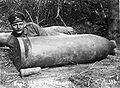 German soldier posing with unexploded shell