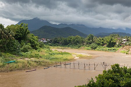 "Working_at_the_consolidation_of_a_wooden_footbridge_in_Luang_Prabang_-_1_(Side_view).jpg" by User:Basile Morin