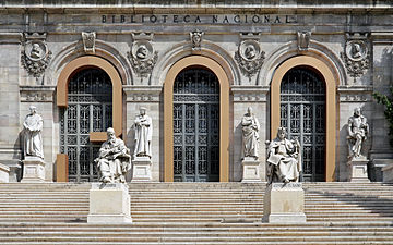 Stairs and main entrance to the National library of Spain with monuments to San Isidoro, Alonso Berruguete, Alfonso X el Sabio by José Alcoverro (1835-1908). - Madrid, Spain
