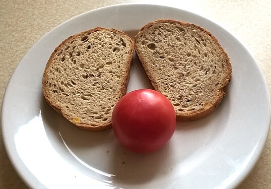 Two slices of wheat bread and a tomato