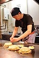A man prepares okonomiyaki