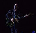 Bono plays guitar during "One".