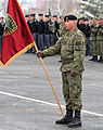 Kosovar soldier with flag