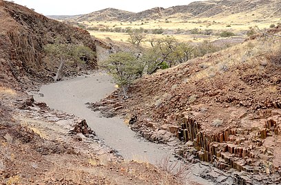 Dry fluvial channel cutting through columnar basalt in Namibia, southern Africa