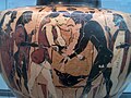 گلدان یونانی با طراحی گرافیک کشتی پلسوس و آتلانتا در بازی‌های در سوگ مرگ شاه پلیاس. پاداش برنده کشتی که پوست و سر گراز کالیدون است در زمینهٔ طرح تصویر شده‌است. نام‌ها با الفبای شالیکز در ابوآ نوشته شده‌است. (۵۵۰ پیش از میلاد)