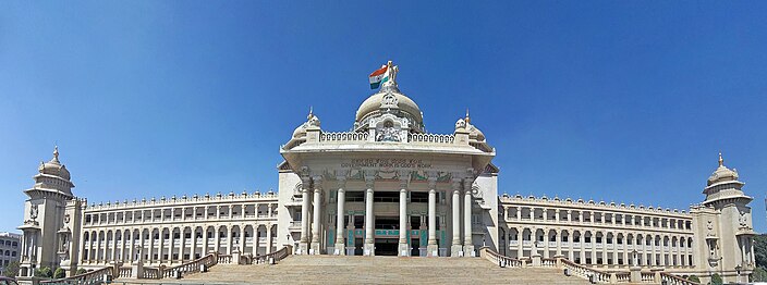 Photo of Bangalore parliament building with 18 archway columns and 10-column entrance under dome with 2 spire towers