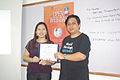 Jojit gives certificate of appreciation to Agnes Reyes.