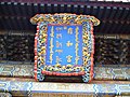 北京の雍和宮(ᡥᡡᠸᠠᠯᡳᠶᠠᠰᡠᠨ ᡥᡡᠸᠠᠯᡳᠶᠠᡴᠠ ᡤᡠᠩ, Hūwaliyasun hūwaliyaka gung)の額に書かれた満洲文字・漢字・チベット文字・モンゴル文字（右から）