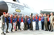 Miss USA 1986 Christy Fichtner and eight runners-up in the First Annual Miss USA Show pose with members of the 41st Military Airlift Squadron near a C-141B Starlifter aircraft (17 June 1986)