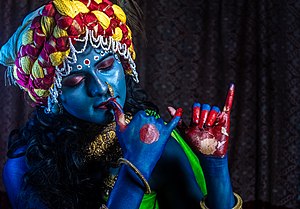 Girl in costume of Krishna